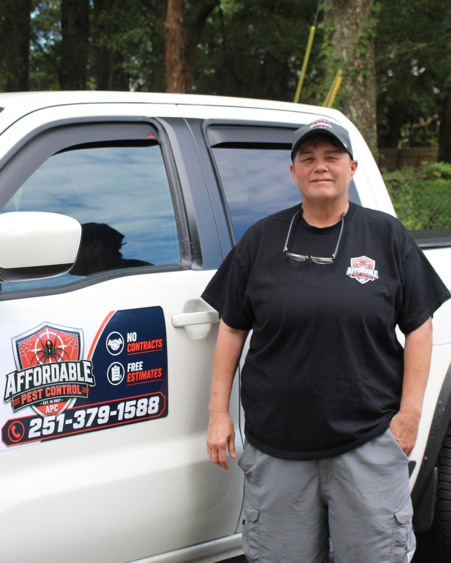 Michelle, owner of Affordable Pest Control, beside her service truck in Mobile, Alabama